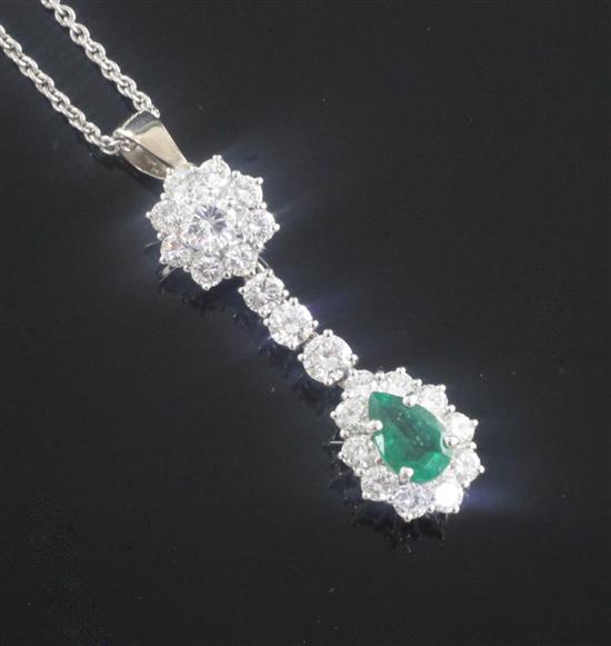 An 18ct white gold, emerald and diamond cluster drop pendant, on a 9ct white gold fine link chain, pendant 1.25in.